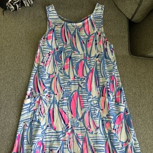 Lilly Pulitzer dress with ruffle bottom and side pockets. Crossed straps on back